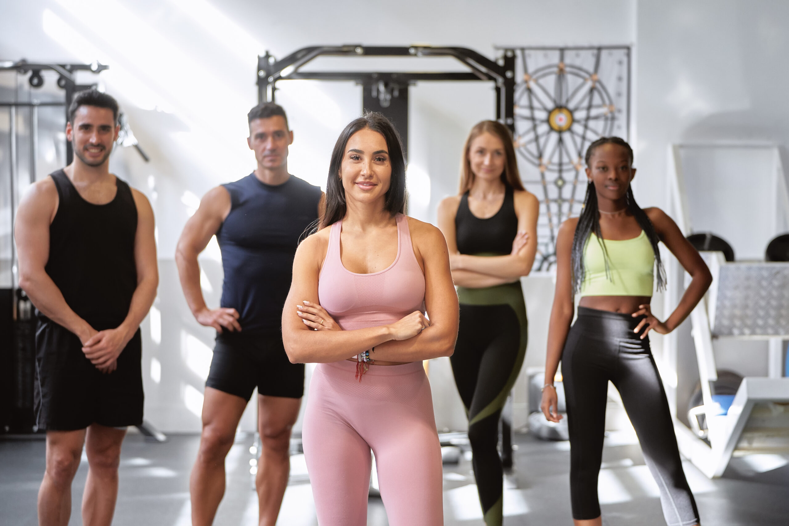 Fitness class with crossed arms in gym